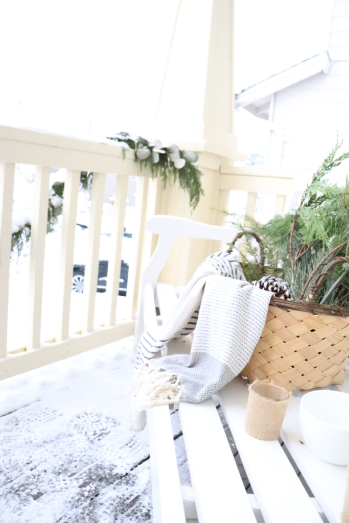 Natural Farmhouse Home Decor - Come see our front porch in the winter! 

pinecones, winter basket with greens and tea towels, burlap wrapped tea lights, garland, front door DIY wreath, birchwood logs, fire logs, winter candles, warm and welcoming front porch