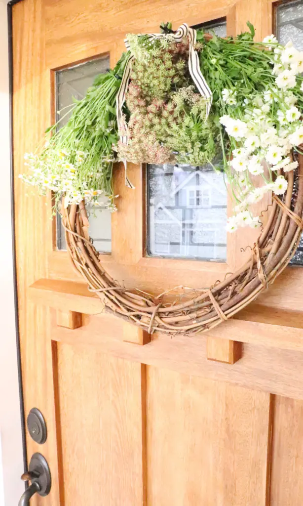 farmhouse front door with spring wreath 