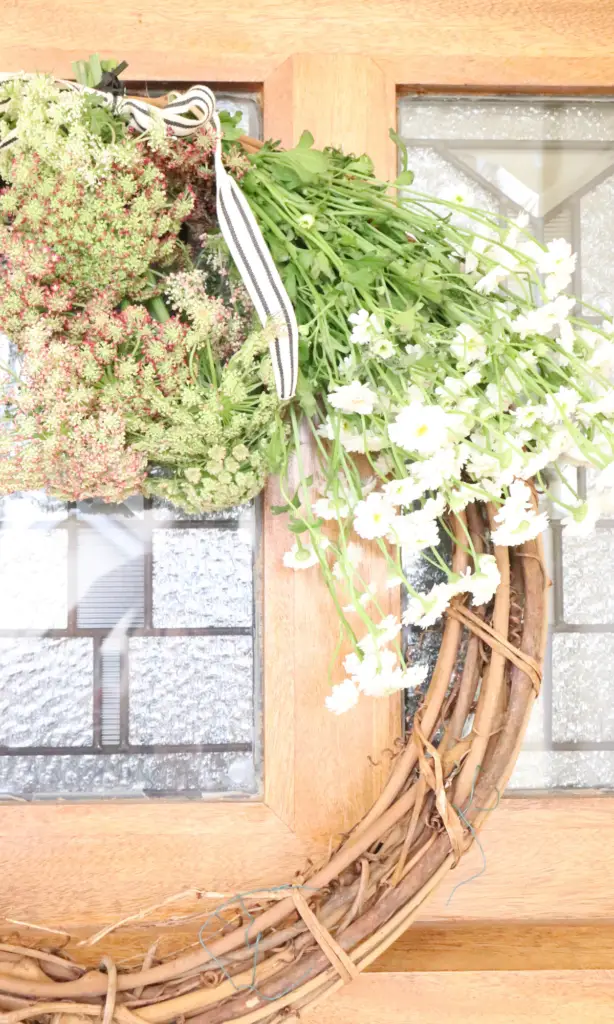 front door wreath with chamomile in a farmhouse