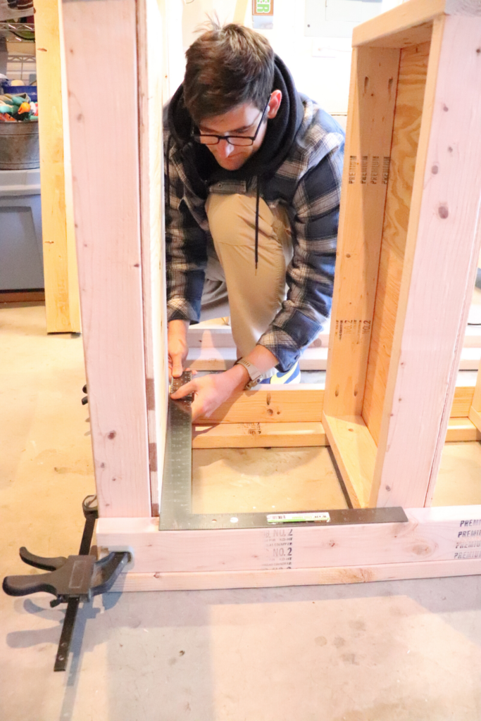 Use wood clamps to hold together the wood in your DIY garage shelf