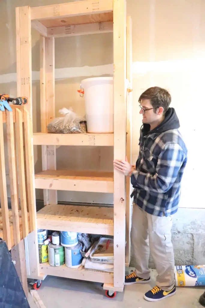 Simple & Cheap DIY Garage Shelf - see how you can organize & store food, household items, home decor, craft tools, chicken feed, and much more with this simple DIY garage shelf! 