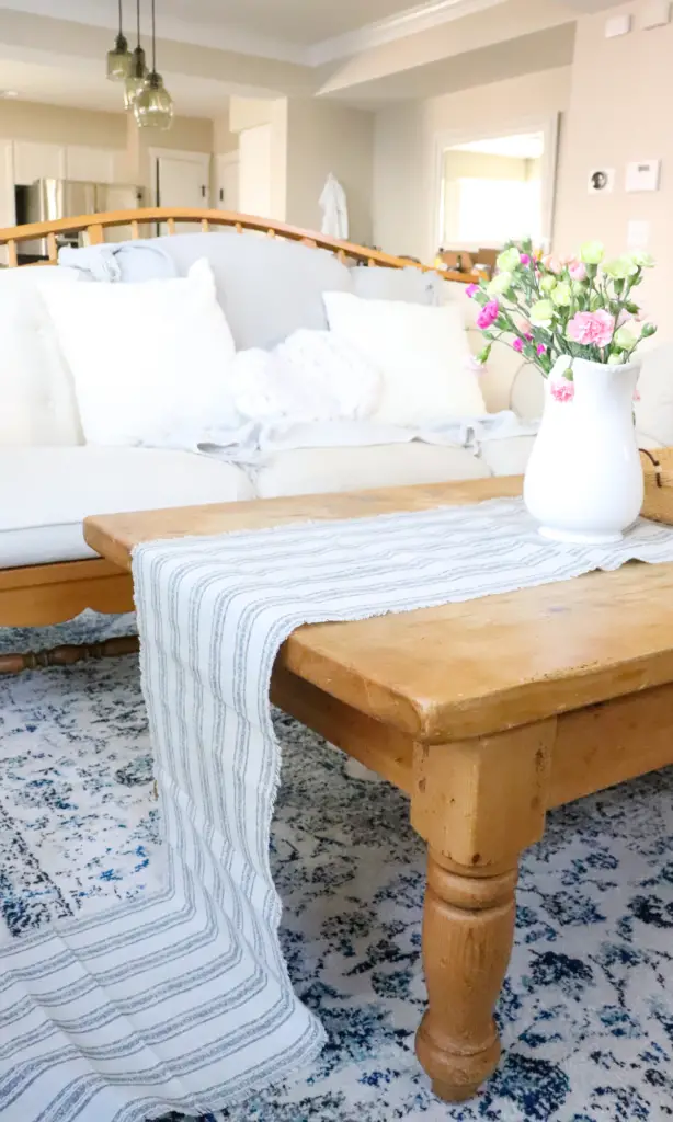 spring farmhouse coffee table beautiful fresh flowers table runner blue rug home decor