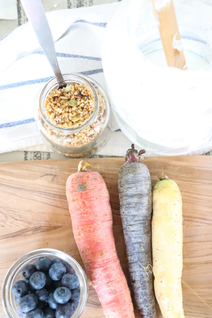 homemade granola blueberries farm to table carrots on a spring brunch table setting