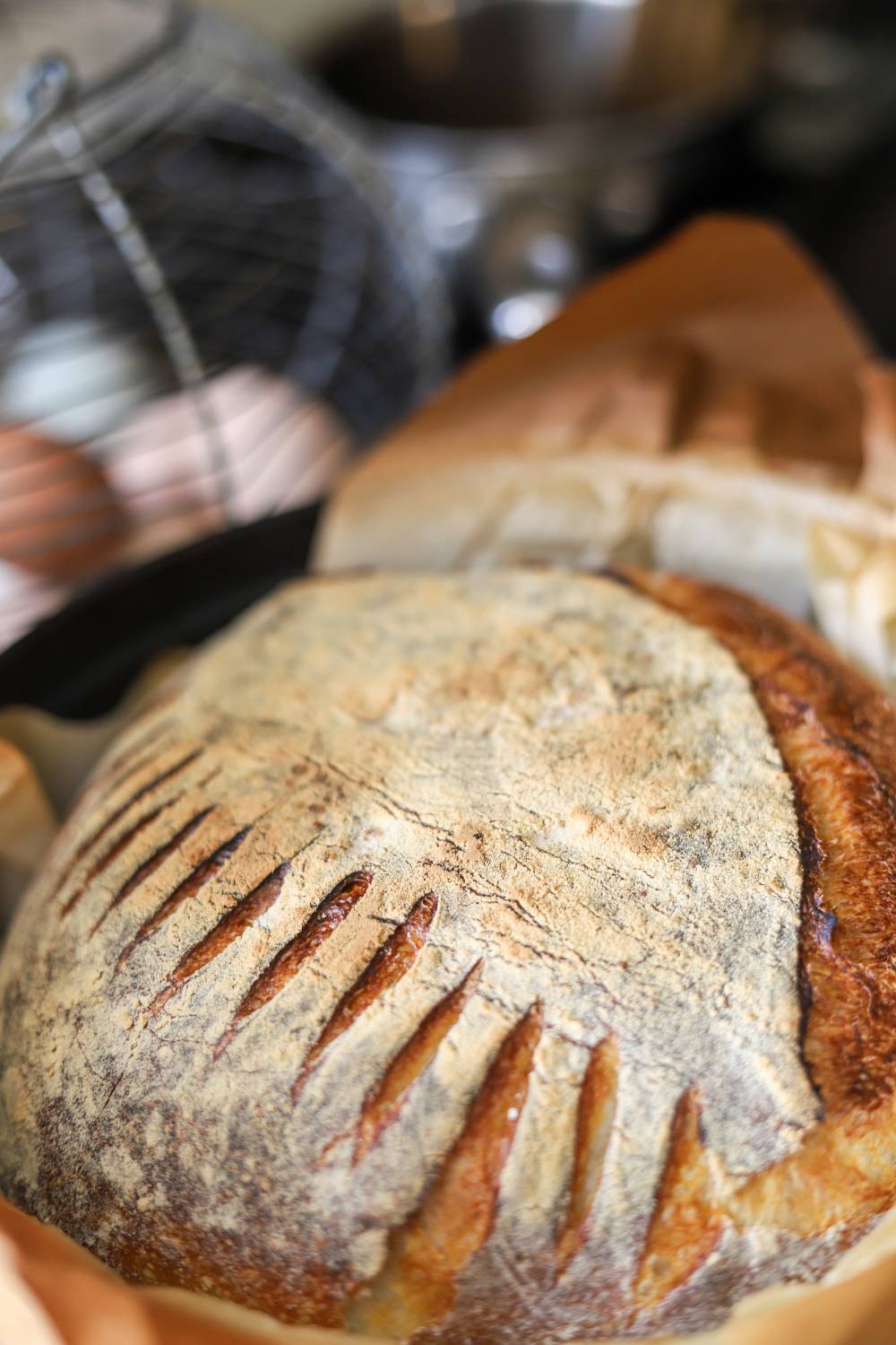 Close-up of a freshly baked rustic sourdough loaf with decorative scoring.