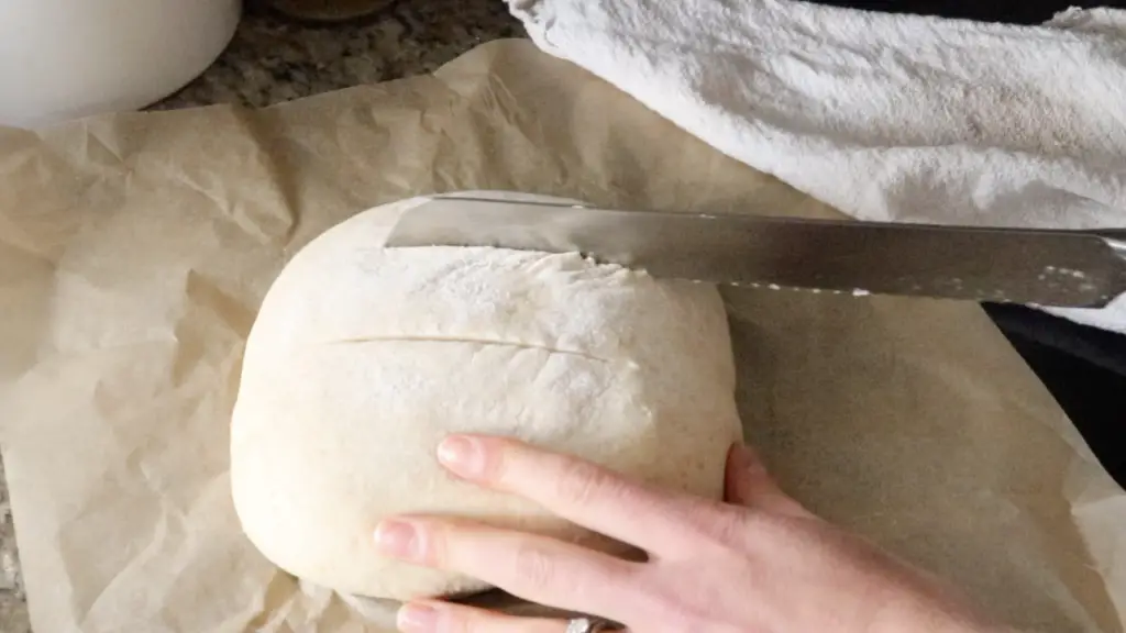 scoring the dough with a bread knife
