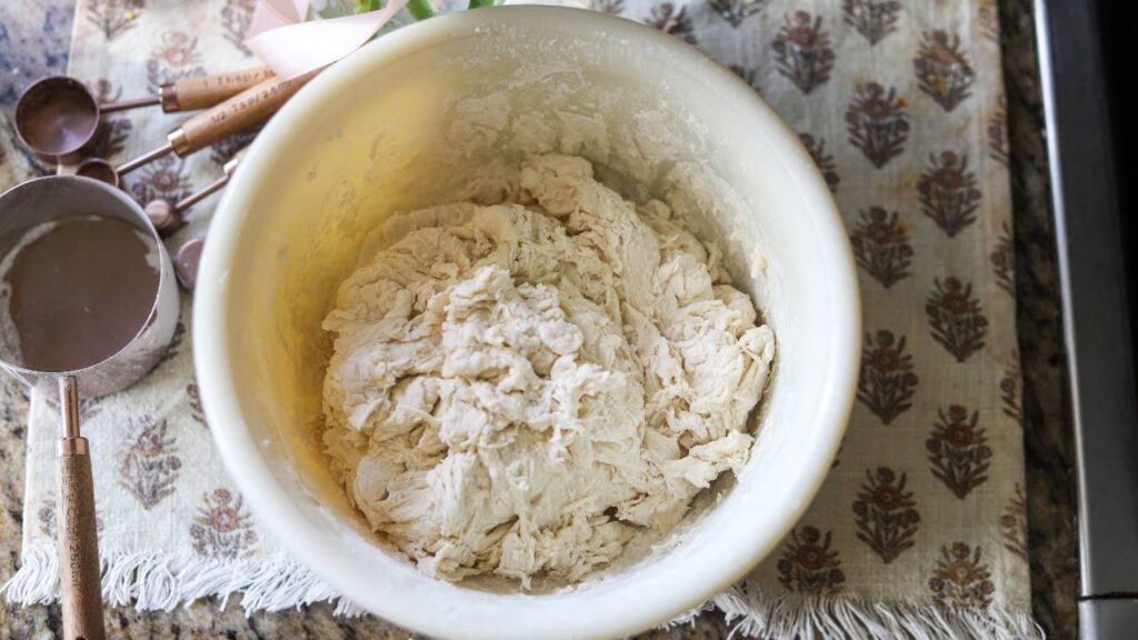 Close-up of freshly mixed dough in a bowl, ready for sourdough bread making.