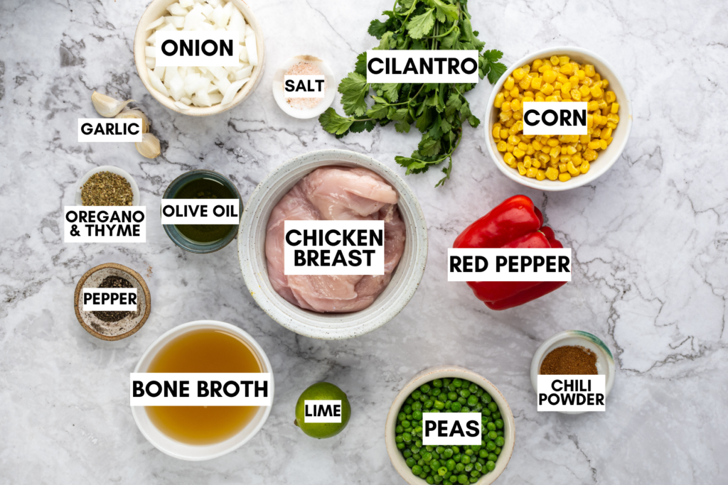 Ingredients for chicken tortilla soup including chicken breast, corn, peas, onion, garlic, bone broth, red pepper, and spices.