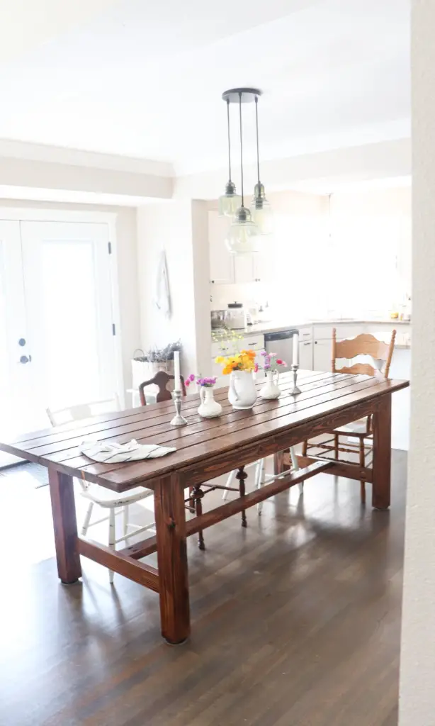 an 8 foot farmhouse dining table with DIY wooden bench in the kitchen