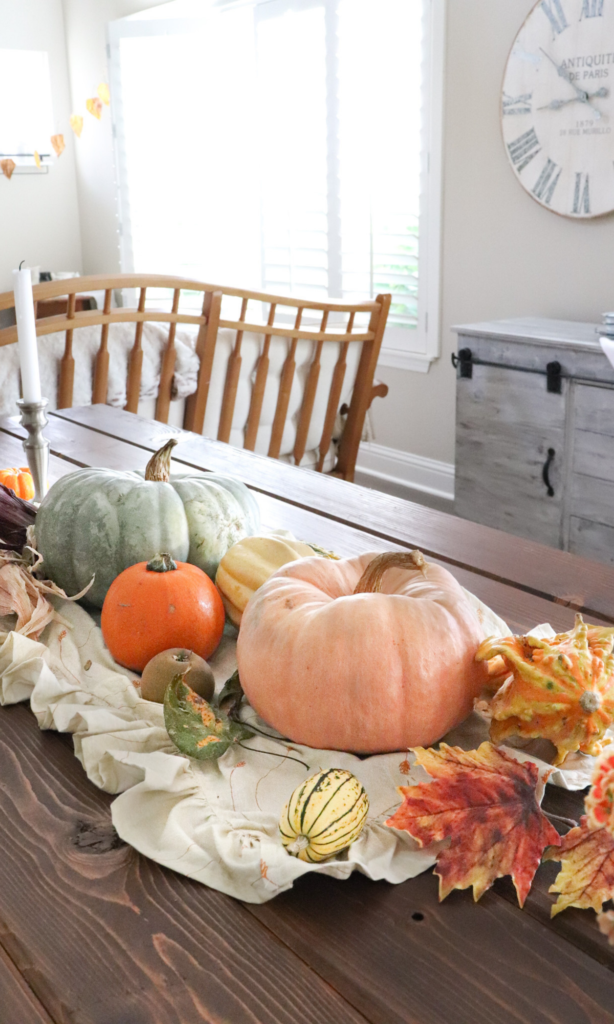 pumpkin, gourd, and dried leaf dining table decor