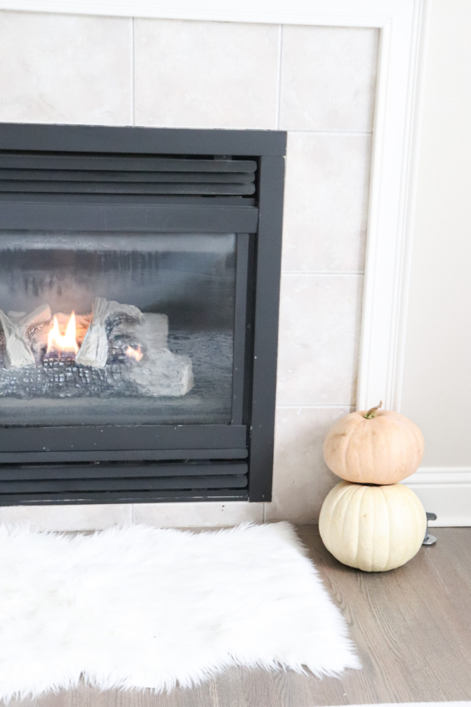 pumpkins next to the fireplace for fall