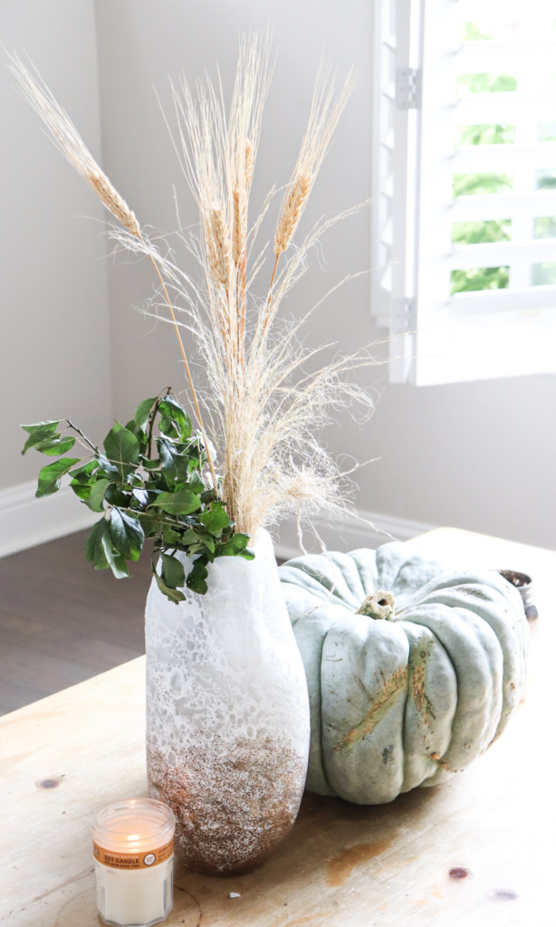 fall florals and a pumpkin with a lit candle