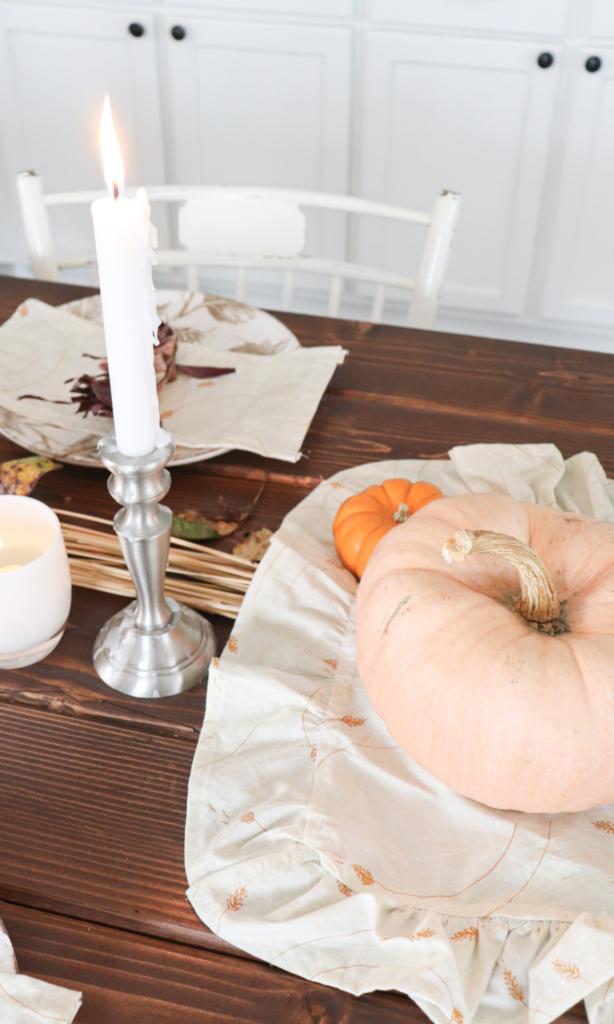 pumpkins and a candle on the table for fall