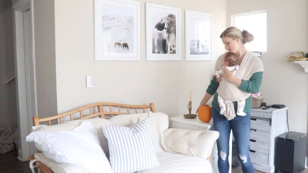 woman with baby decorating for fall