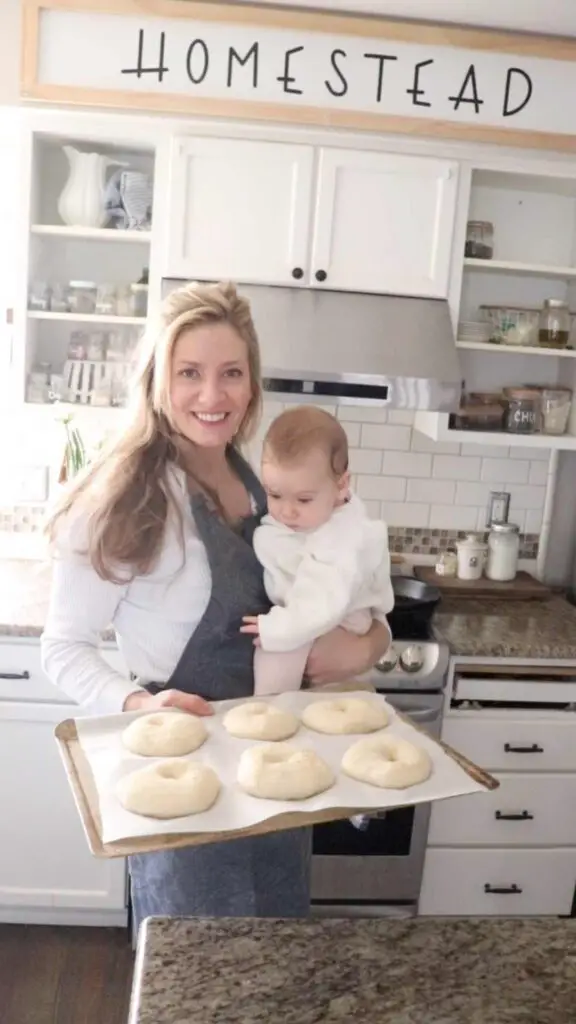sourdough bagels before they are cooked, with my cute baby on my hip
