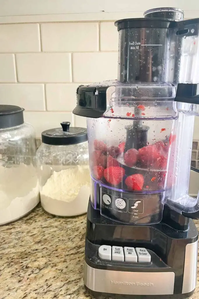 putting the strawberries in a food processor 