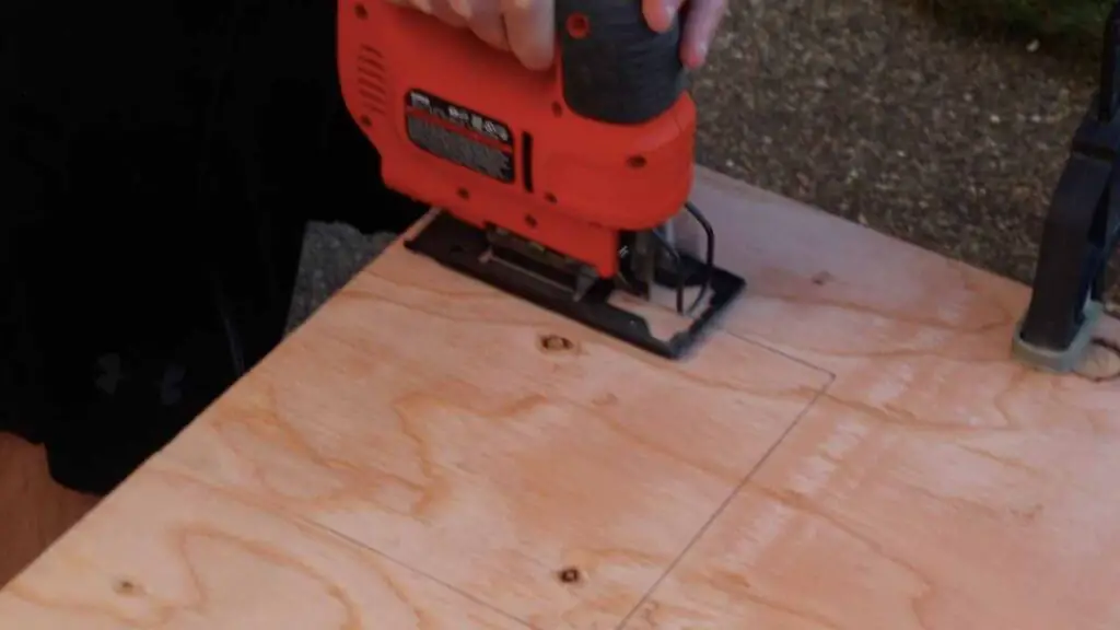 cutting a hole for the automatic chicken coop door
