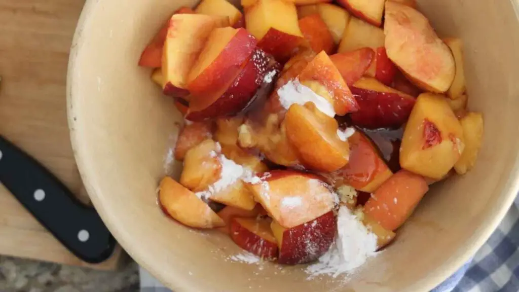 sliced peaches in a bowl with arrowroot powder