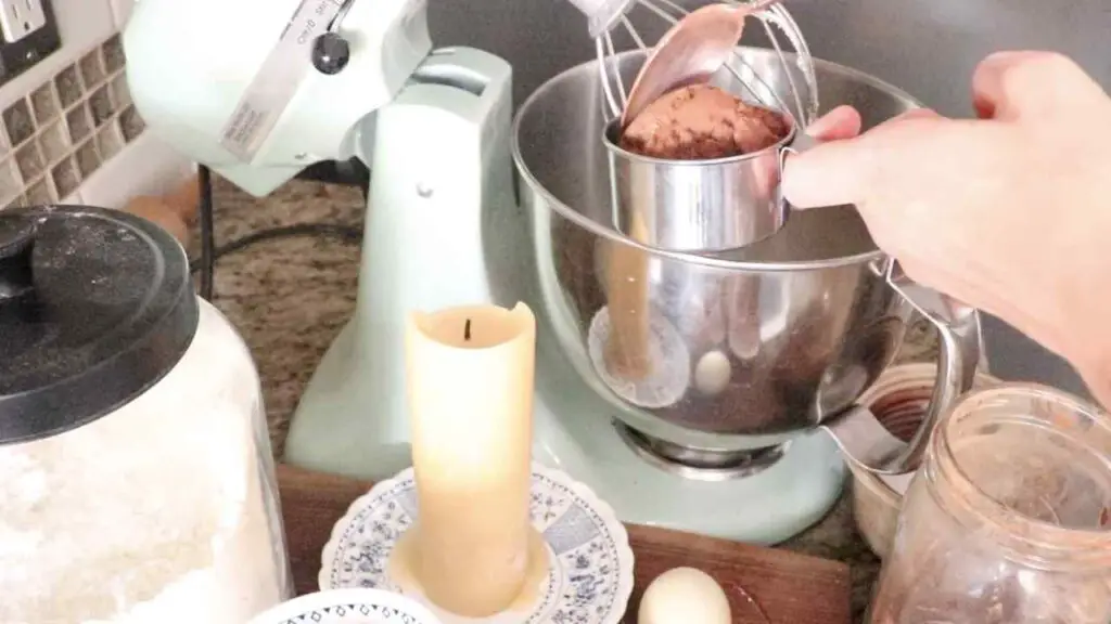 adding cocoa powder to the cupcake mixture