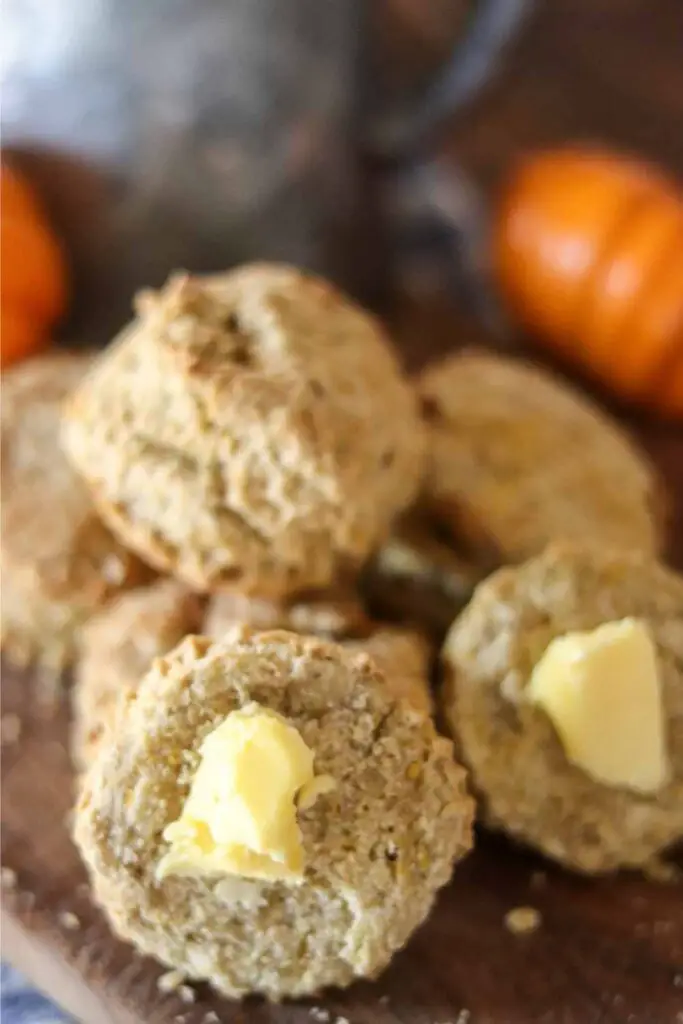 sourdough discard pumpkin biscuits with farm fresh butter on a wood platter