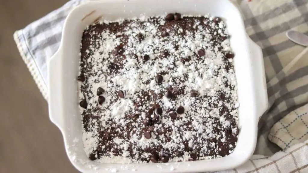 white baking dish of Einkorn chocolate chip brownies on a blue and white cloth
