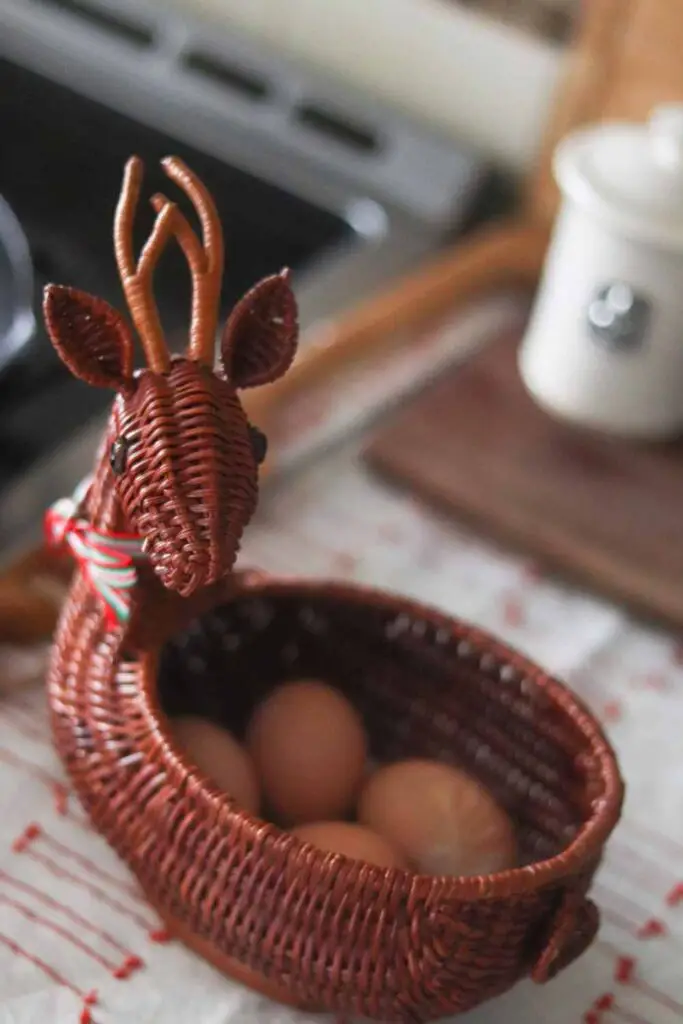 reindeer wicker basket holding fresh brown eggs