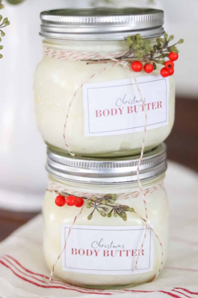 Two stacked jars of homemade Christmas juniper berry body butter