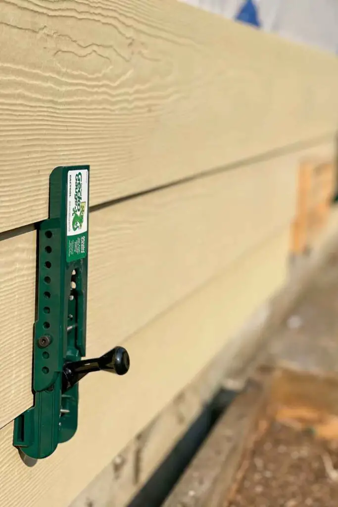 a gecko gauge being used to hold siding boards