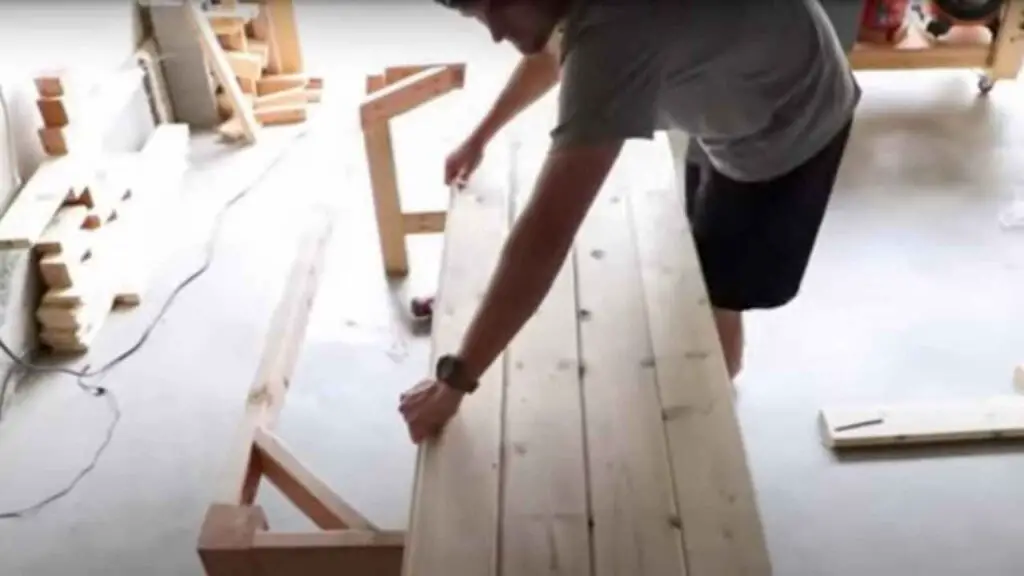 attaching tongue and groove boards to the table frame to create a farmhouse dining table