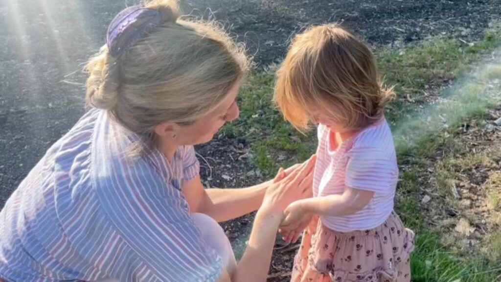 mother applying homemade sunscreen to toddler daughter