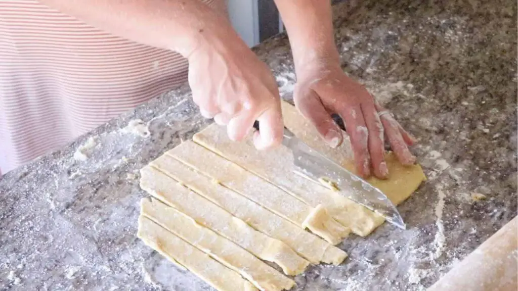 cutting einkorn sourdough pie crust dough into strips