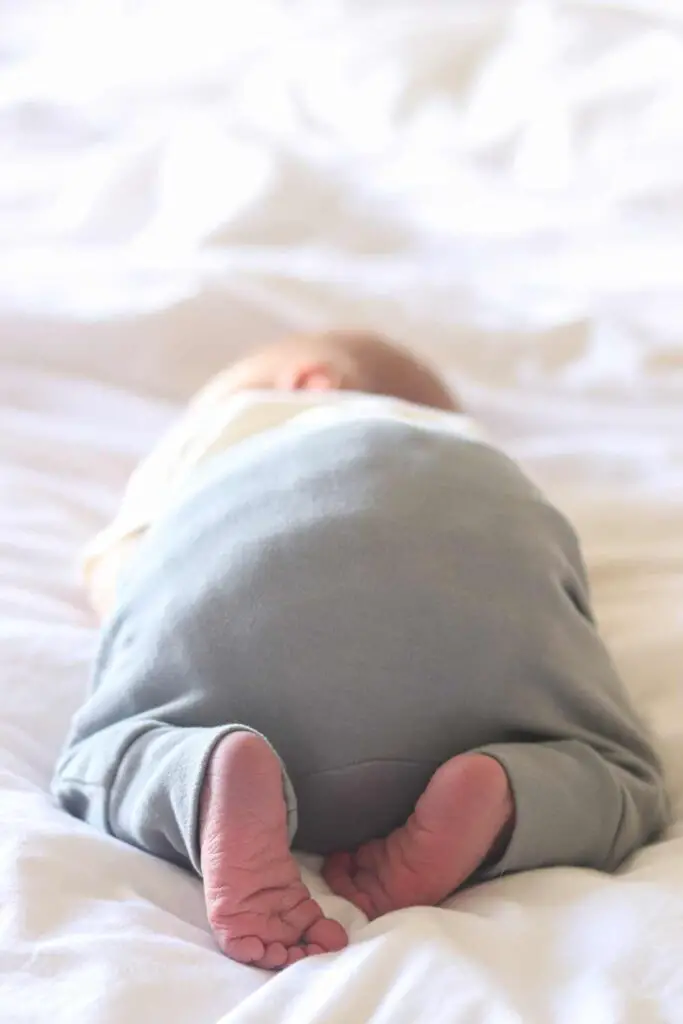 A newborn baby laying on his stomach