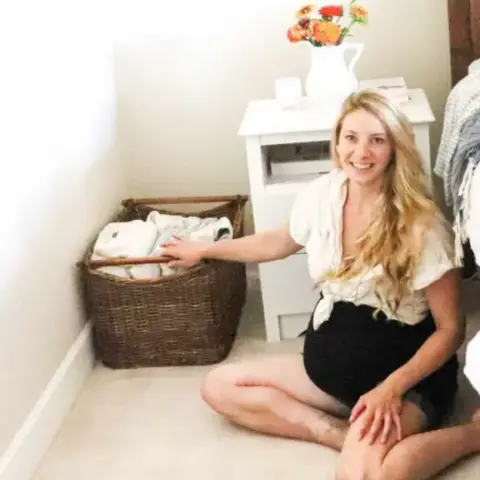 Sitting on the floor with a basket of home birth supplies