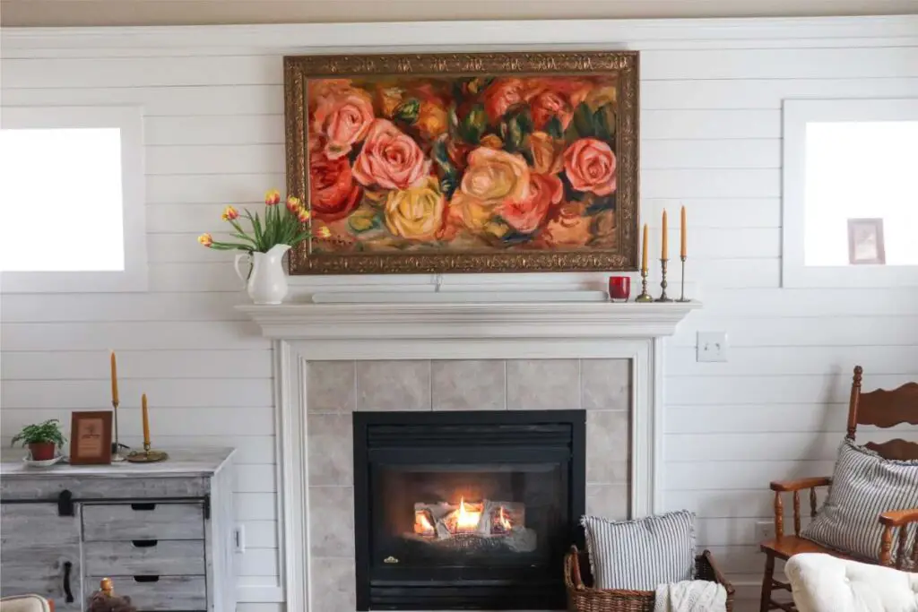 a frame tv mounted above a fireplace
