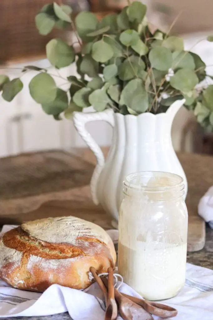 sourdough einkorn bread on a table with sourdough starter