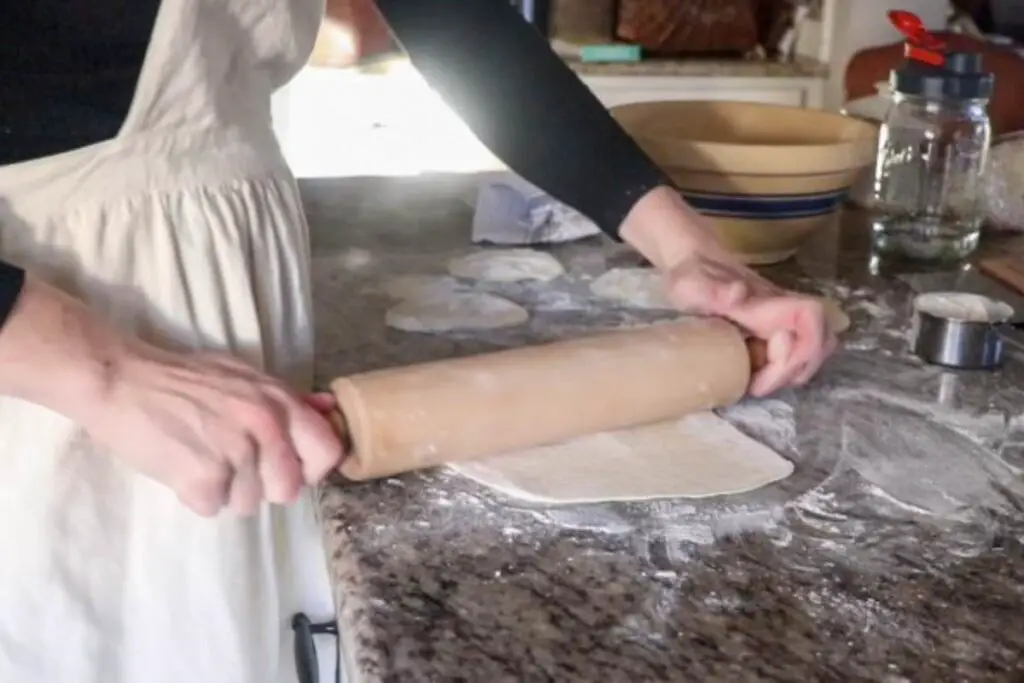 rolling out einkorn sourdough discard tortilla dough