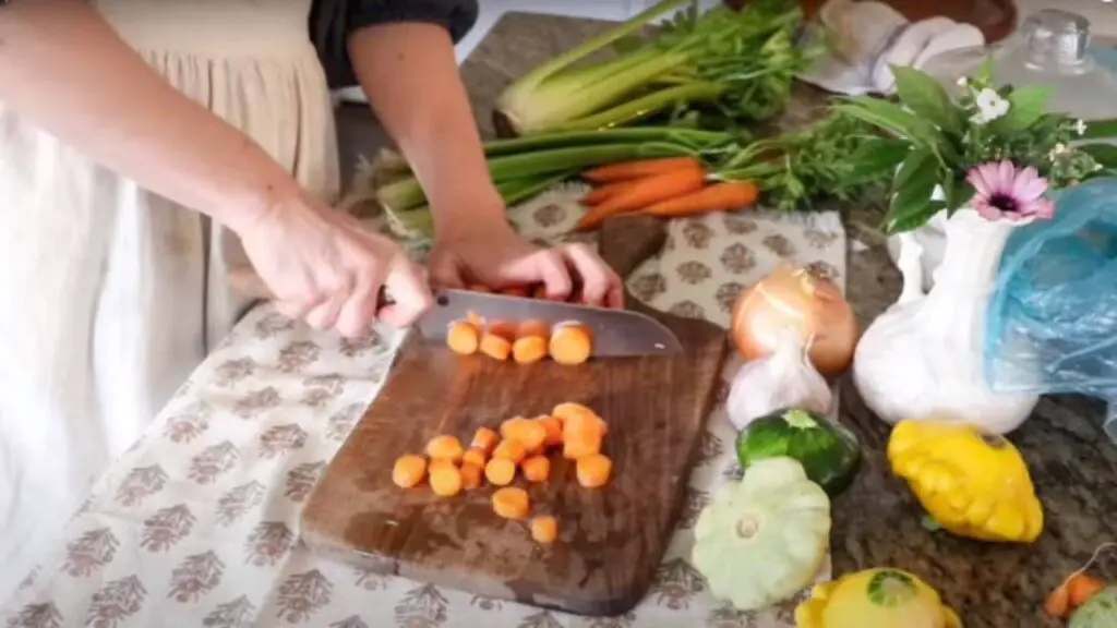 Chopping carrots for a sourdough chicken pot pie.