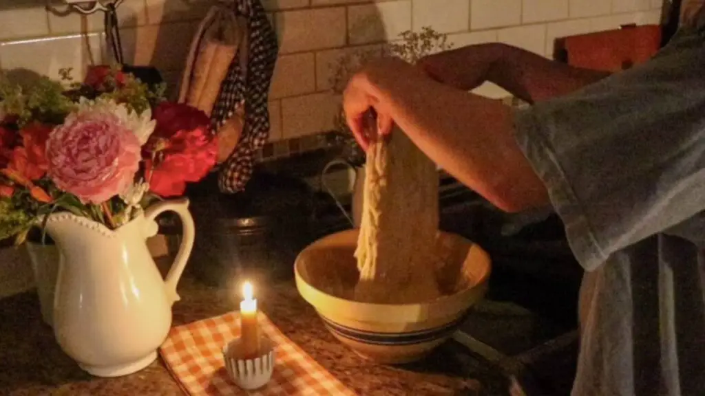 Performing stretch and folds on some einkorn sourdough sandwich bread dough by candlelight. 