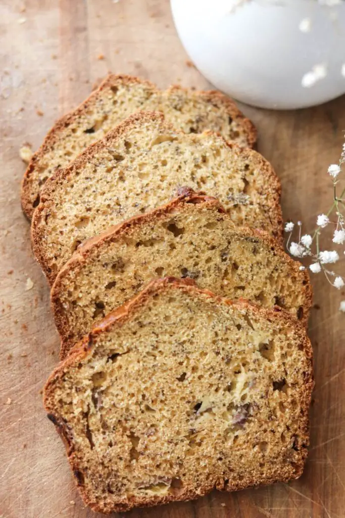 Slices of banana bread on a wooden cutting board.