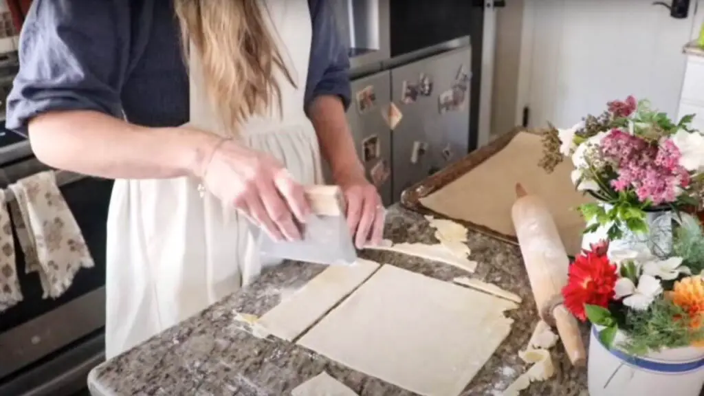 Cutting the pop tart dough into rectangles with a bench scraper.