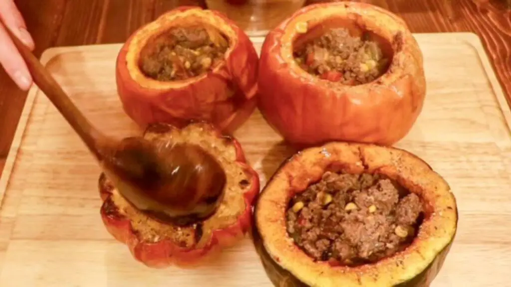 Filling cooked pumpkins with beef soup.