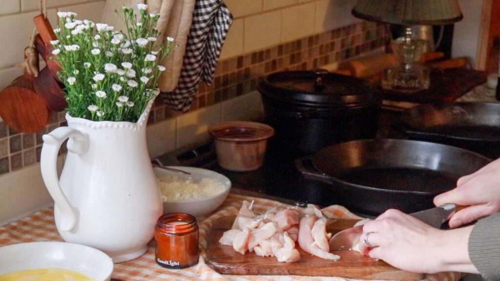 Cutting up a chicken breast.