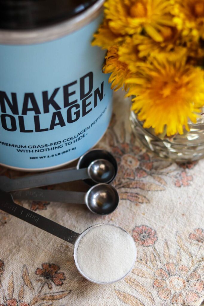 A jar of collagen powder next to a spoonful of collagen.