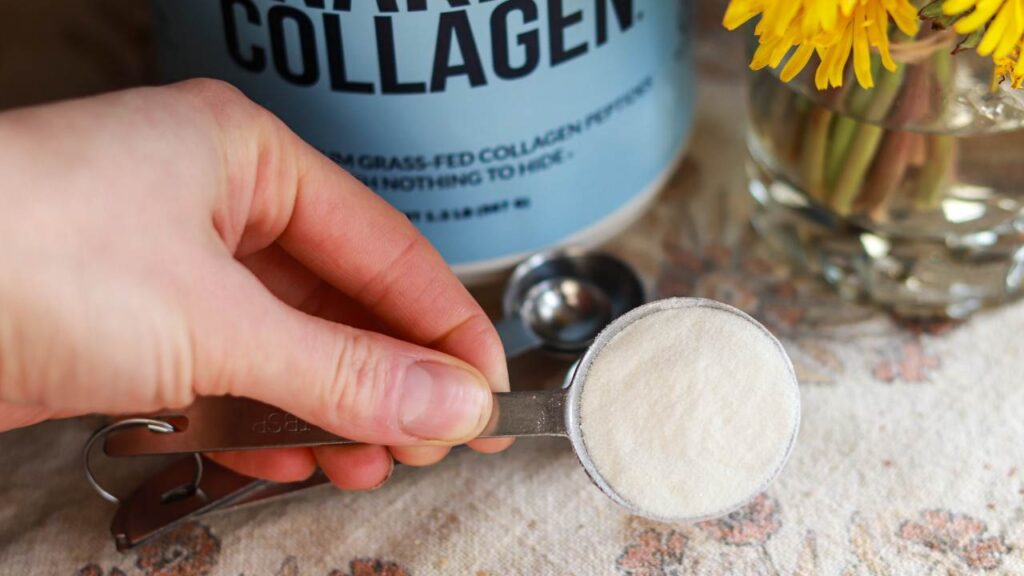 Holding a spoonful of collagen poweder.