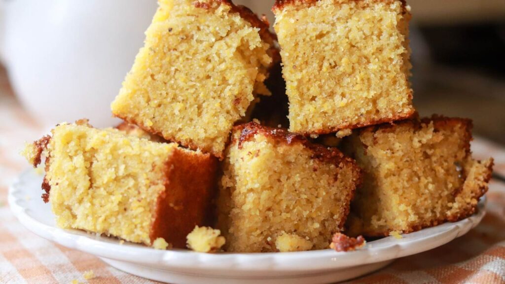 A plate of cornbread squares stacked tall.