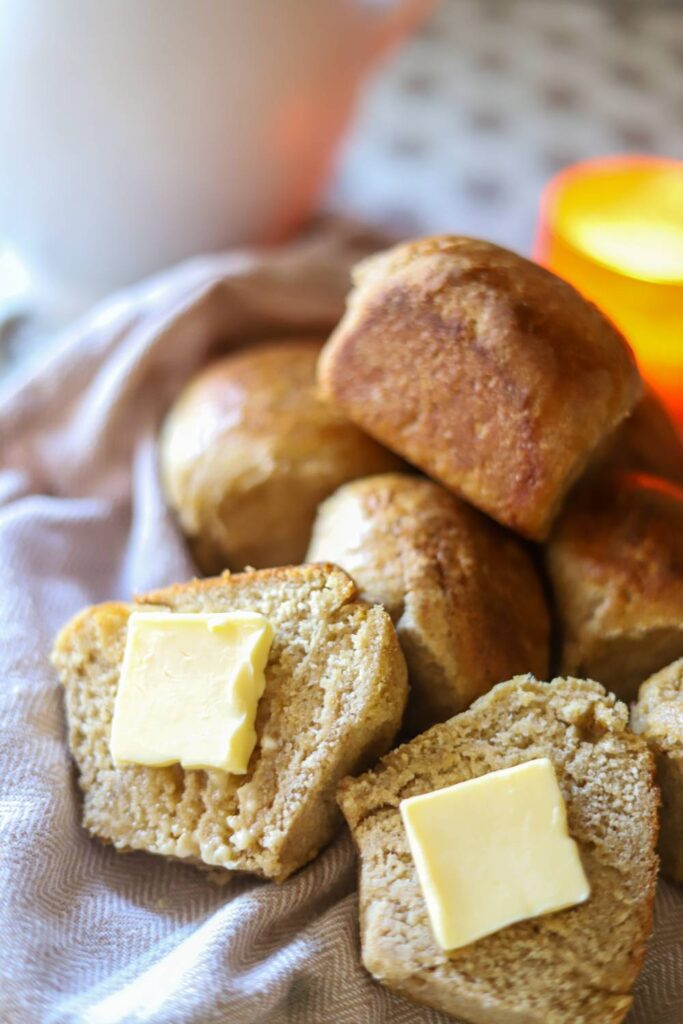 Freshly baked sourdough roll split open with butter on top