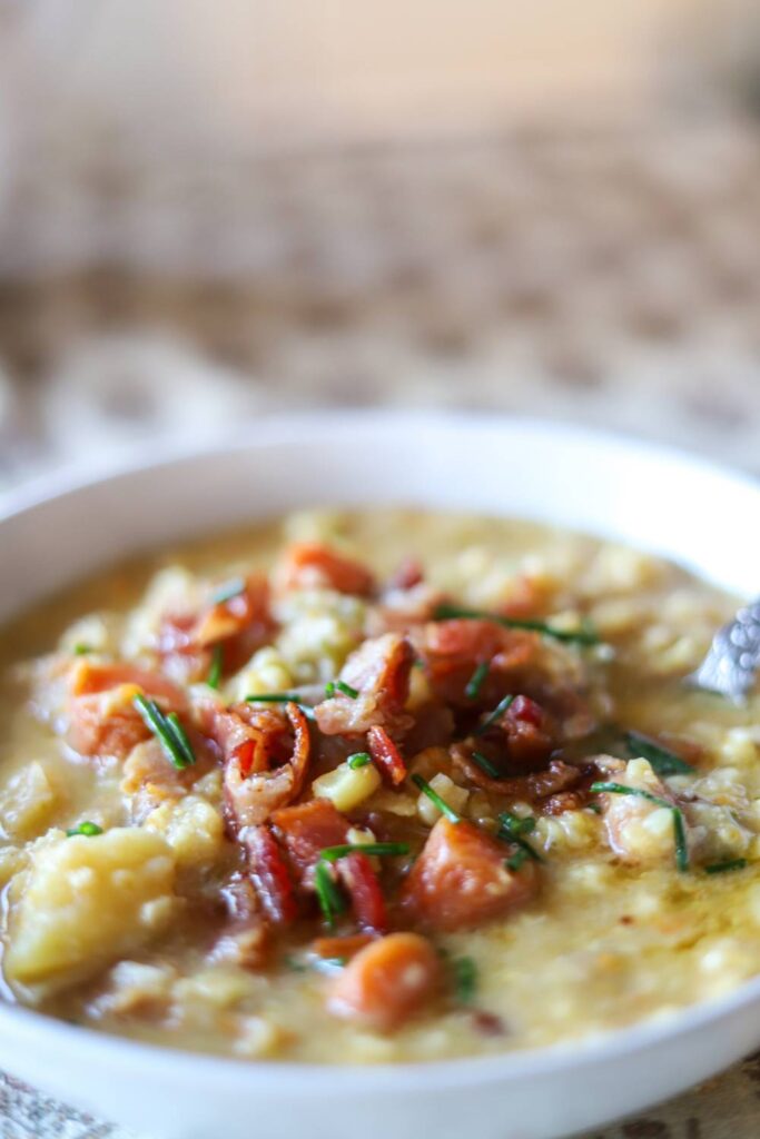 Bowl of creamy corn chowder with bacon recipe topped with chives.