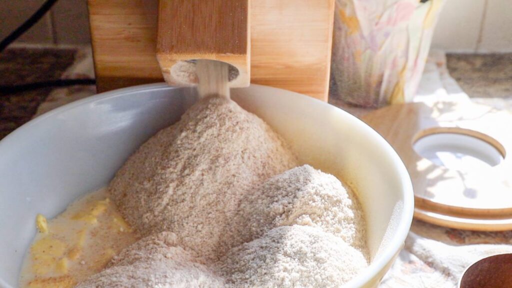 Freshly milled flour falling into a mixing bowl