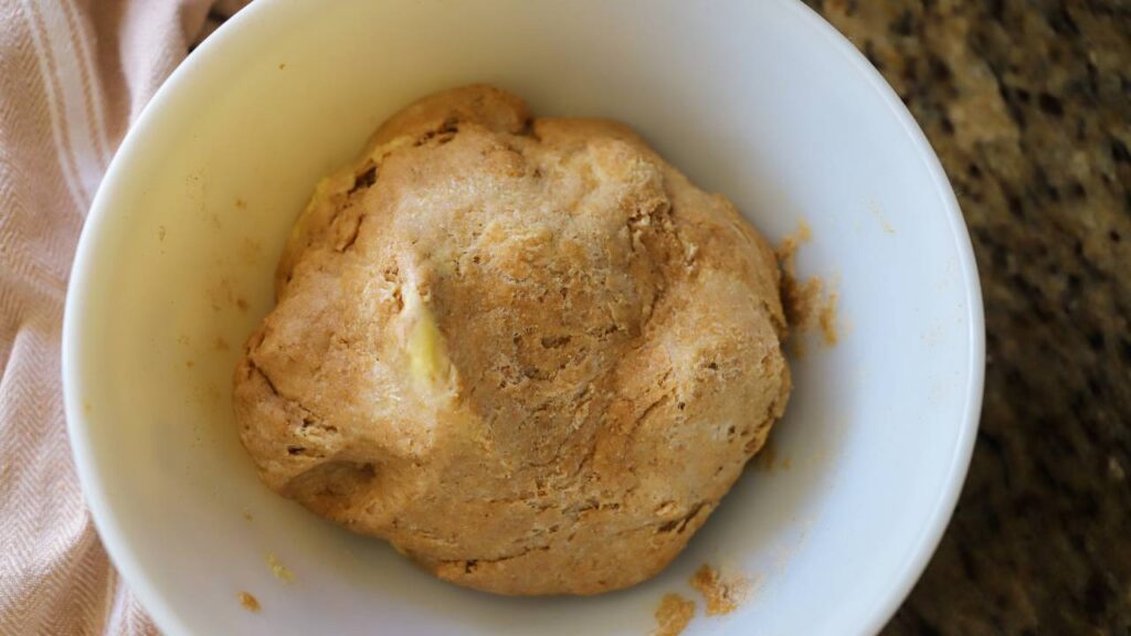 Ball of sourdough dough in a white bowl