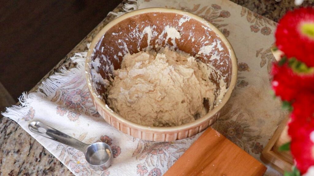 a medium mixing bowl with mixed up pancake batter in it.