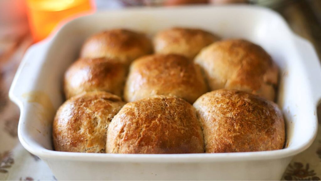 Golden brown baked sourdough rolls in a dish
